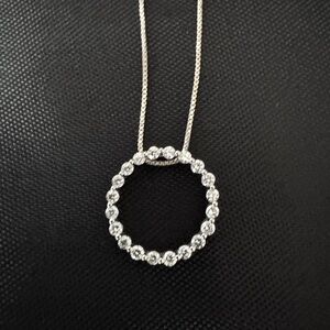Eternity circle pendent is 18 k white gold with beautiful  diamonds.